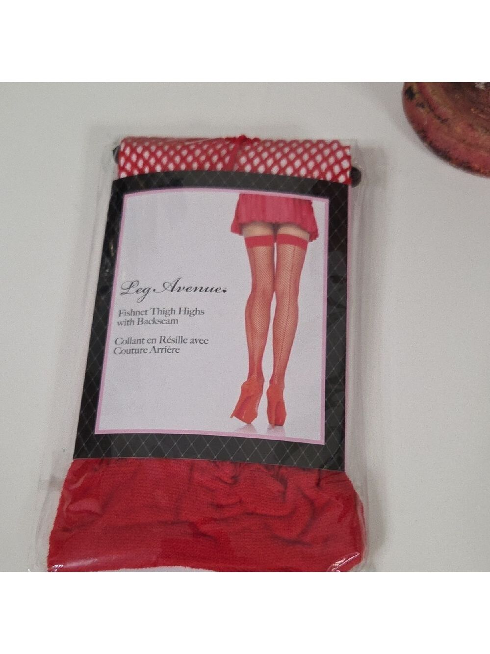 Red Leg Avenue fishnet thigh-high stockings featuring a backseam and lace top.